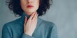 © ArtPixel-Portfolio - Woman touching her neck, experiencing discomfort and pain, a symptom of sore throat, thyroid inflammation, or illness