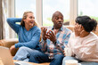 © Iryna - Friends talk and laugh together in a cozy living room during a weekend gathering
