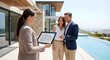© Olga - Real estate agent showing floor plans on digital tablet to a happy couple at a modern luxury villa for home buying concept and aspirational lifestyle