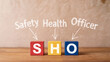 © Aminograpix - SHO Safety Health Officer Acronym Text on Wooden Blocks