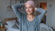 © LimeSky - Female cancer patient in a wig standing in her bedroom