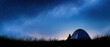 © Juiy - Night sky star tent camping silhouette grass horizon galaxy outdoor travel Silhouette camper night sky with glowing tent near grass horizon, peaceful stargazing scene with bright galaxy arch