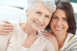 © Reese Coop/peopleimages.com - Portrait, happy and old woman with daughter in home for love, affection and bonding together. Smile, people and embrace with senior mother for family visit, parent support and relationship connection