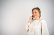 © Nenad - Confident businesswoman using smartphone isolated with space for text