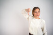 © Nenad - Unhappy businesswoman showing thumbs down gesture isolated with copy space