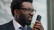 © Yuliia - Angry stressed authority African American man business guy male businessman in office yelling loud in mobile phone conflict smartphone call blaming shouting bad work communication misunderstanding