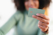 © Studio Marmellata - A person holds a payment card, showcasing financial technology and modern transactions.