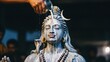 © TheseusStock - Close-up of a hand pouring milk over a Shiva statue during a traditional Hindu ritual, symbolizing devotion and purification.