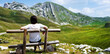 © Ievgen Skrypko - Girl sitting on wooden bench in mountains of Montenegro. Young girl resting in National park Durmitor with scenic nature view