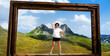 © Ievgen Skrypko - Girl with wooden frame in National park Durmitor, Montenegr. Young woman making photo with beautiful nature landscape and mountains