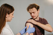 © dsheremeta - Healthcare professional applying bandage after vaccination