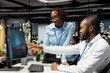 © DC Studio - Black colleagues team using AI analytics platform for monthly data reports, reviewing neural networks algorithms and automation for business productivity. IT company representative at work.