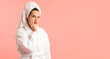 © New Africa - Woman wearing bathrobe with hair wrapped in towel on pink background. Space for text
