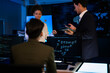© ultramansk - Industrial design team planning future transport strategy. Executive presenting new smart mobility concept and market trend analysis on digital board during late night workshop.