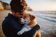 © Jdgkxbnc - young person hugging a tan and white dog on a sunlit beach at golden hour, tender affectionate moment by the ocean waves and cliffs