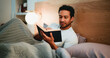 © BuyOutFelix06/peopleimages.com - Reading, book and man in bedroom at night in home with relax for hobby, knowledge or entertainment. Calm, late and male person in bed with fiction story, novel or literature on weekend in apartment.