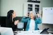 © laddawan - Asian senior and middle aged businesswomen reviewing documents and reports in office. Professional teamwork, mentorship, business collaboration