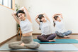 © buritora - Women doing yoga and pilates in a yoga studio or yoga class (sports gym)