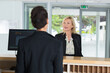 © auremar - guest asking questions from the receptionist