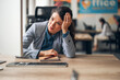 © Jelena - Businesswoman experiencing burnout and emotional exhaustion at corporate office