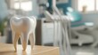 © Trisna - Dental model rests on a wood table, dental equipment in blurred background