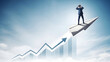 © Ghyna - Businessman in blue suit stands on rising arrow graph looking ahead