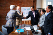© StockImageFactory - Senior Indian Asian businessman shaking hands after closing successful corporate deal