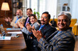 © StockImageFactory - Senior Indian executives applauding successful business presentation in modern corporate office