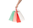 © Somphop - A person's hand holding a paper shopping bag with handles on a clean white background. Studio shot with ample copy space for text, logos, or branding. Isolated on white, cut out.