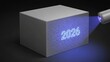 © Sajiman - Ultraviolet light reveals hidden 2026 on a gray cube, symbolizing future discovery.
