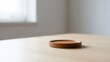 © Andriea - Minimalist wooden coaster on a light wood table, soft light from window