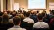 © VistaVisions - Rear view of blurred audience listens lecturer at public company workshop. Corporate professional coaching, academic convention concept