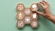 © Design World24 - Hand carefully placing wooden block representing environmental wellness among health concept icons