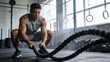 © Rekha - Athletic Man Doing High Intensity Battle Ropes Workout in Industrial Gym, Strength and Fitness