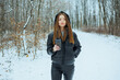 © DSMT - Walking in the snow with a coffee cup in a forest during winter