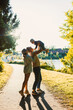 © DSMT - Family enjoys time at the park while playing with their child near the water on a sunny afternoon