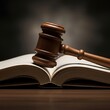 © KB Kalmati - Close up of a judicial hammer lying across the white pages of a law book symbolizing authority and legislation.
