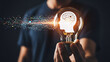 © Hridoy - Human hand holding light bulb with brain icon and digital data stream representing ai innovation and idea generation