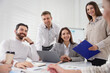 © New Africa - Businesspeople working together at table in office