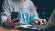 © krungchingpixs - Cybersecurity and digital privacy. Person use smartphone and laptop with virtual shield, padlock icons. OTP authentication, data protection, secure login, network security and online identity safety.