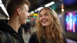 © Mrammon - A young man and woman are smiling at each other in a subway station