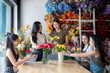 © Wasana - Women florists creating flower arrangements in workshop