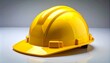 © Waqar - Glossy yellow hard hat on reflective surface.
