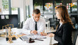 © Nuttapong punna - Professional lawyer consulting a client about legal contract in modern office, law and justice concept, business agreement, legal advice