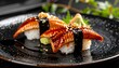 © JAKET - Close-up of two pieces of nigiri sushi on a black patterned plate, featuring glazed eel, seaweed, rice, wasabi, and pickled ginger
