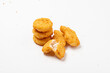 Crispy nuggets are stacked and scattered, showcasing their golden texture and inviting looks