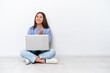 © luismolinero - Young caucasian woman with laptop sitting on the floor isolated on white background applauding after presentation in a conference