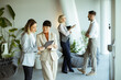 © BGStock72 - Team members discuss ideas in modern office space during a workday