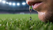 © gabriel - A close-up of a man's face with a drop of water hanging from his mouth on a green grass field