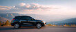 © perfectlab - Black compact SUV parked on mountain road with scenic valley and mountain range in background during sunset